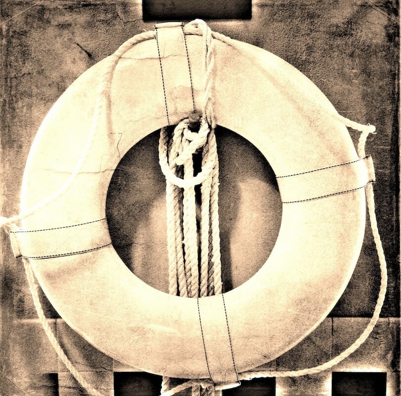 Life preserver hanging from a wall used to save people in water rescues.