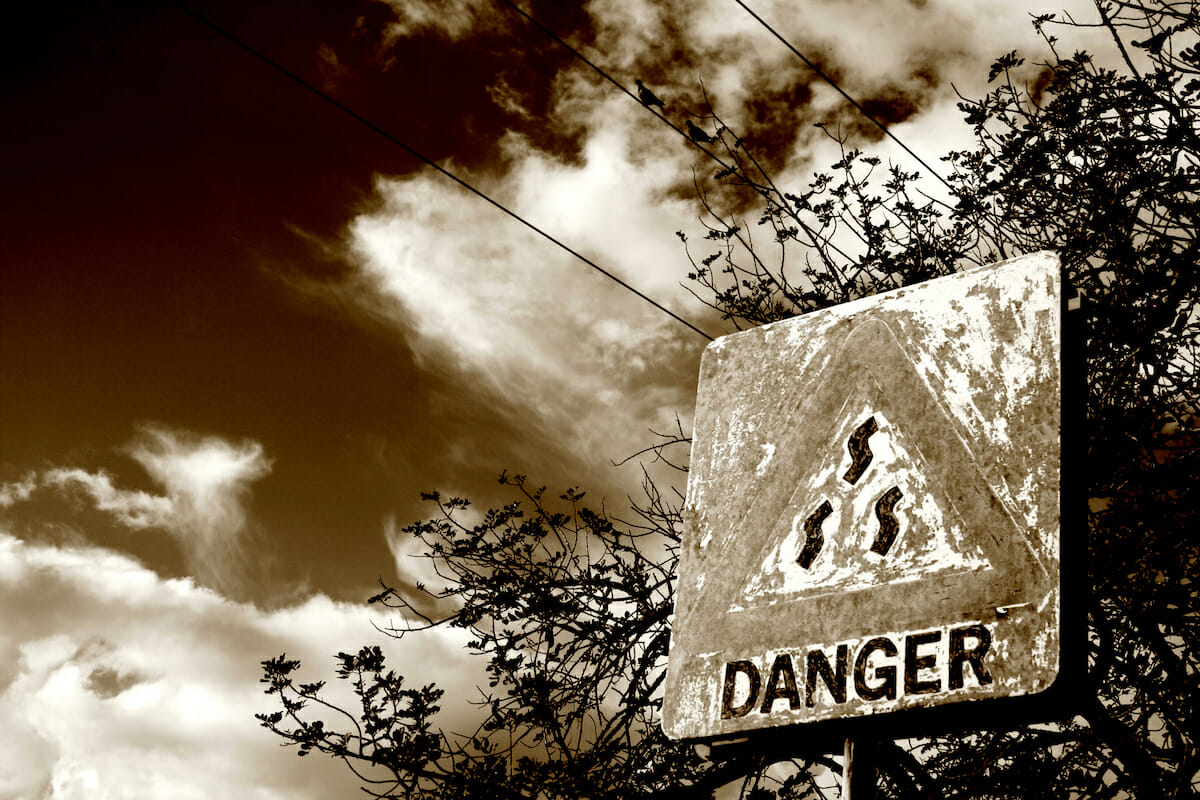 An old danger sign in sepia tone